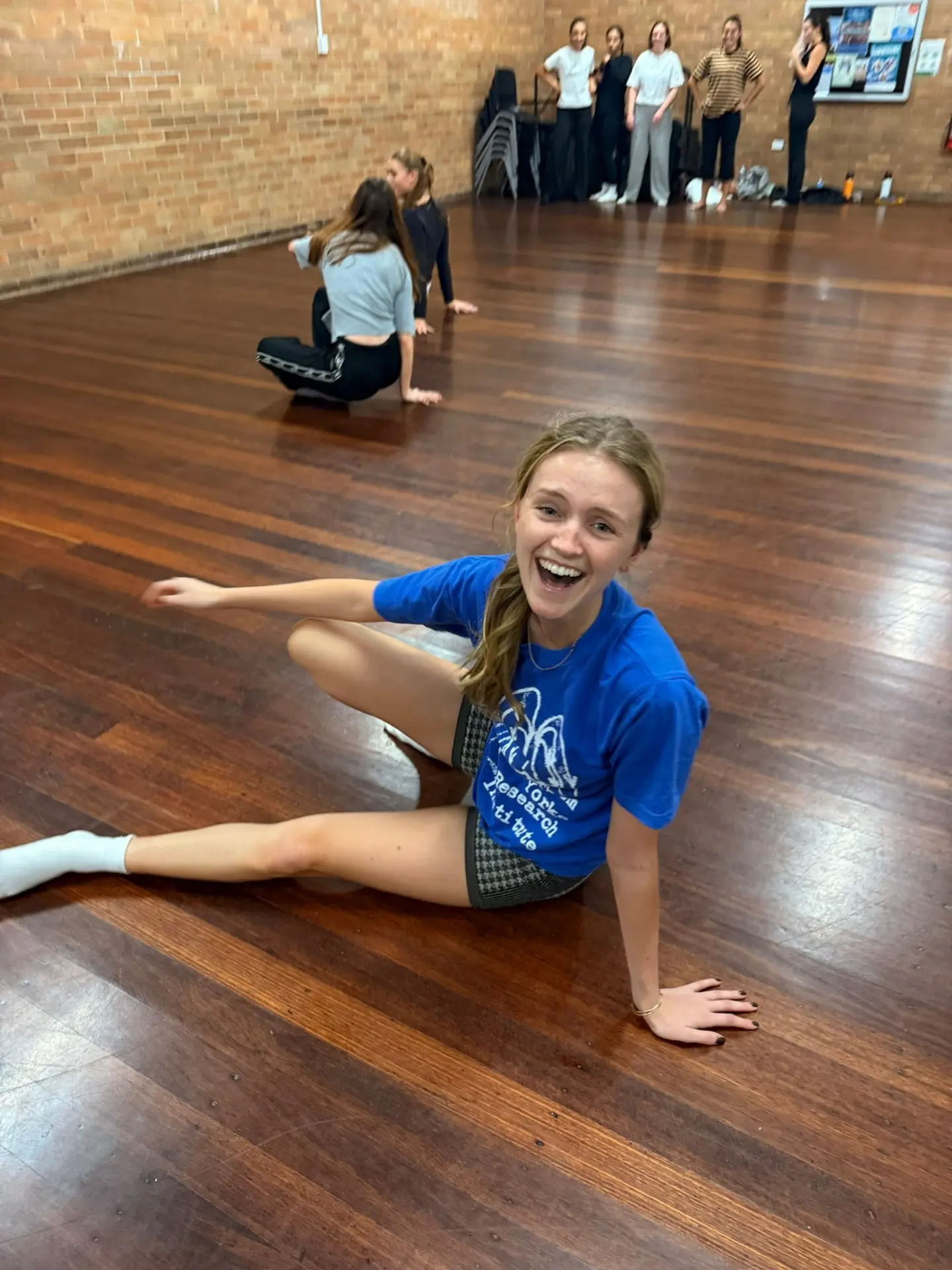 A NoCo dancer smiling on the timber floor during class