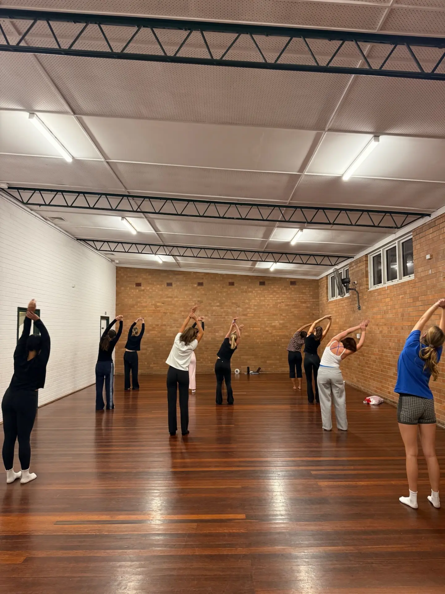 A NoCo class warming up together with side stretches